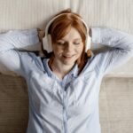 Woman listening to music with great noise cancelling headphones